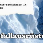 LVS-Gerät, Metallschaufel und Sonde im Schnee vor verschneiter Berglandschaft