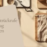 Symbolbild Produktrückrufe: Akku-Werkzeug, Käse und Babykleidung auf einem Tisch